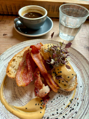 Espresso and Eggs Benedict served on a plate at Flotsam & Jetsam London