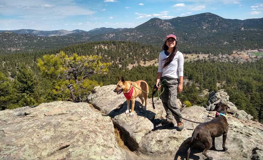 Abigail with her dogs at the summit of Evergreen Mountain