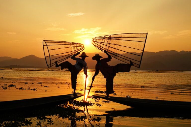 Fishermen posing on Lake Inle at sunset