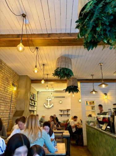Interior of Flotsam & Jetsam, London with people enjoying their meals