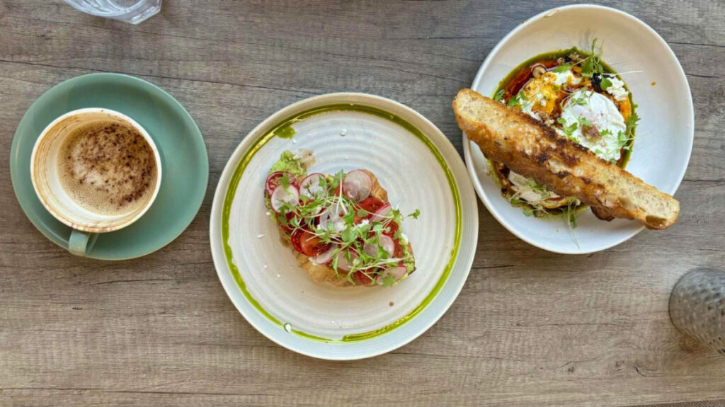 Plates of Tomato mozzarella croissant and Turkish eggs served at Parker Cafe, Victoria