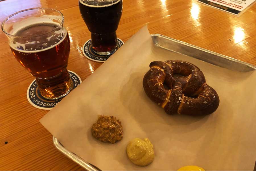 View of a pretzel and beers on a table
