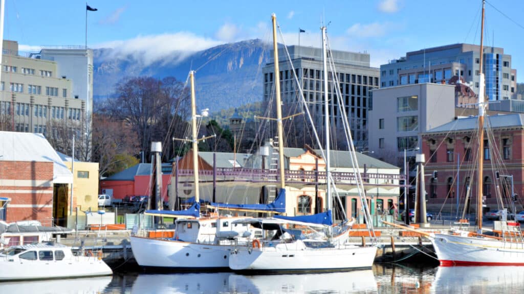 View of the docked boats in Hobart Harbour with mountain view in the background
