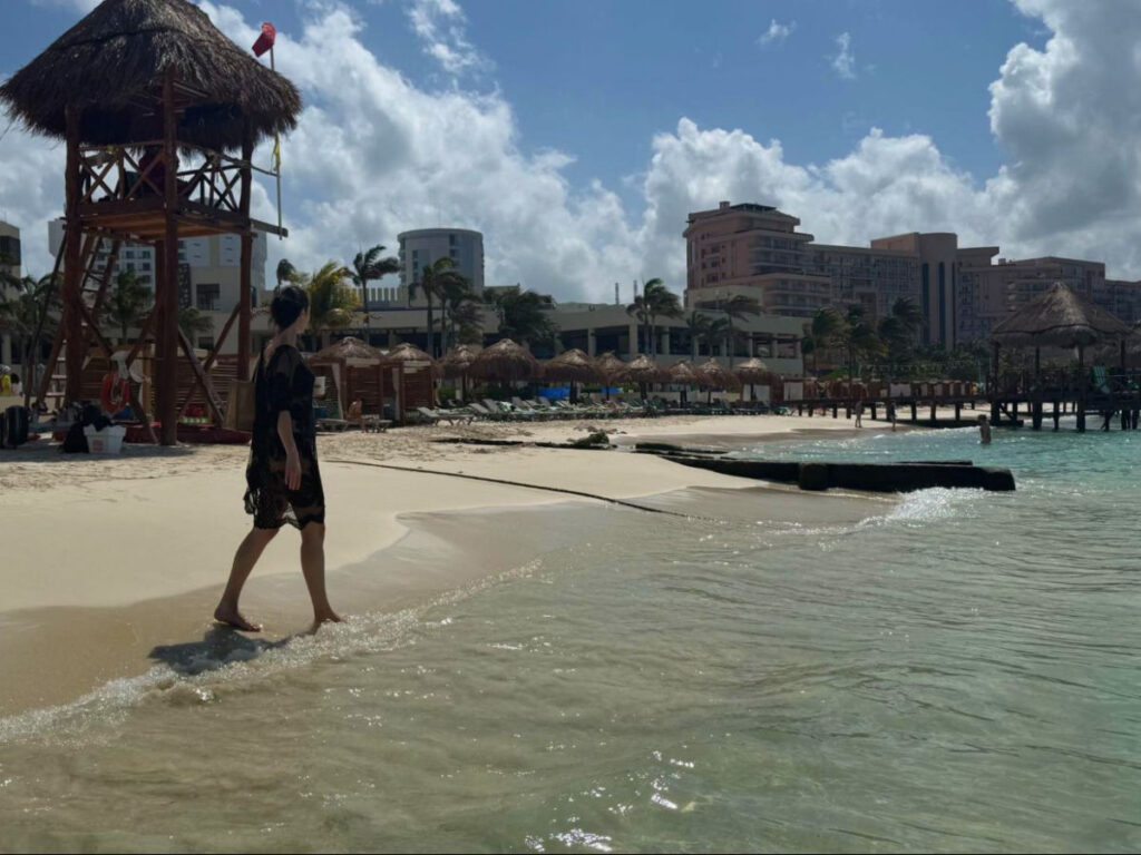 Author Niamh walking on Hyatt Ziva Cancun resort’s private beaches