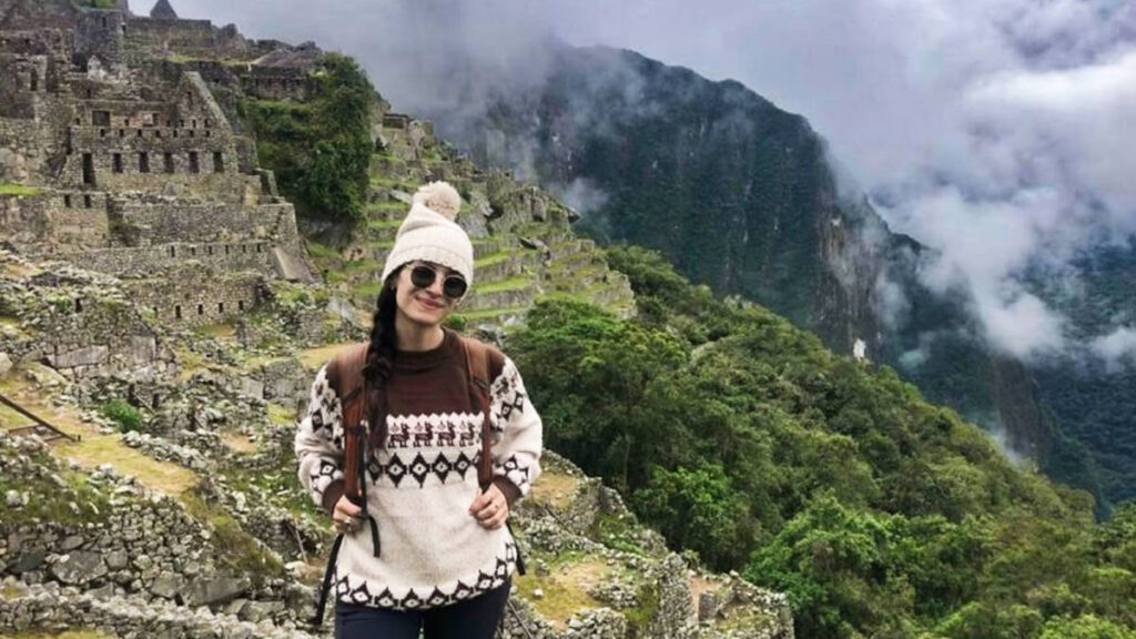 The author McKenna Mobley, posing for a photo with the Machu Picchu in the background