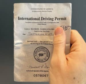 Hand holding an International Driving Permit