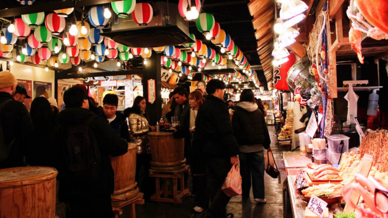 View of people at night in Nishiki Market in Kyoto, Japan