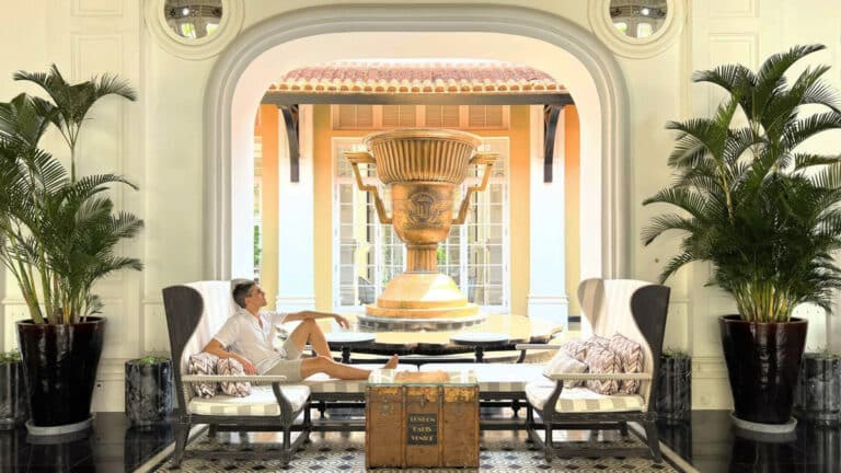 Nate Hake posing for a photo with the championship cup on his background in JW Marriott Phu Quoc Emerald Bay Resort & Spa