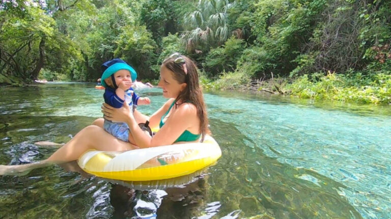 View of the author holding her child in a float on the river at Kelly Park Rock Springs