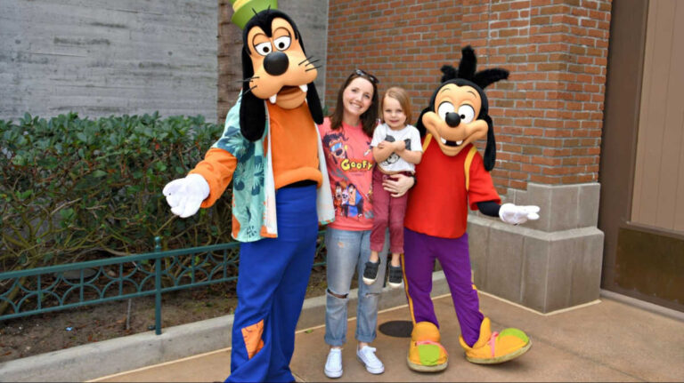 The author Katie and her son posing for a photo with Max and Goofy at Disney’s Hollywood Studios