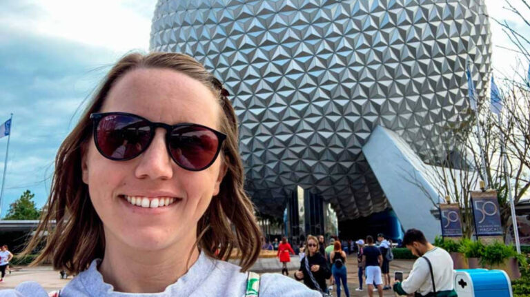 The author Katie Neufeld smiling for a selfie with the Spaceship Earth