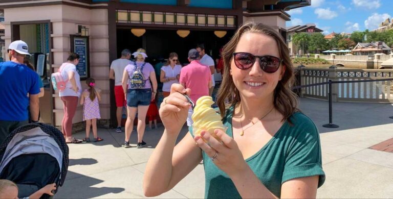 The author Katie Lusnia enjoying her classic pineapple DOLE whip from Swirls on the Water in Disney Springs