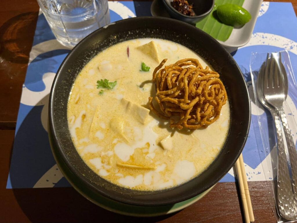 A bowl of khao soi on a restaurant in Northern Thailand