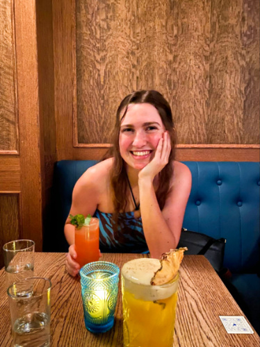 The author Laura McFarland, holding her glass of cocktail at Horsefeather