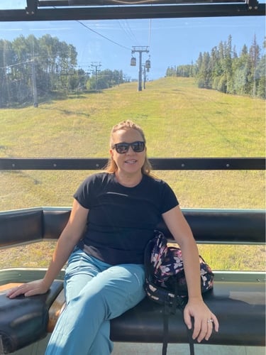 Laura Falin smiling while riding a cable car in Colorado