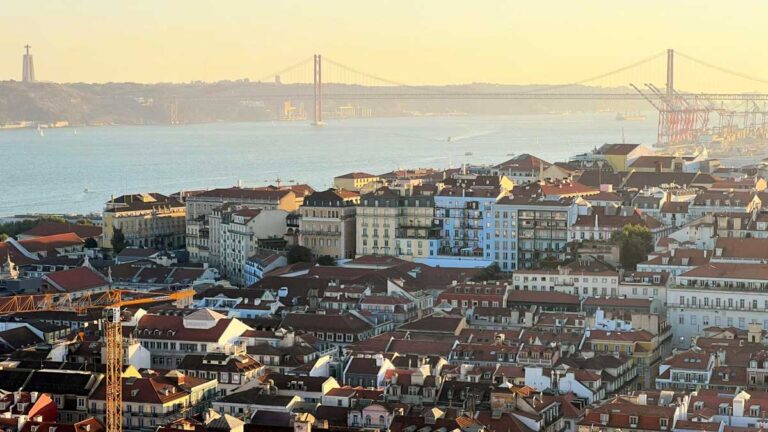 Aerial view of Lisbon waterfront and buildings during sunrise