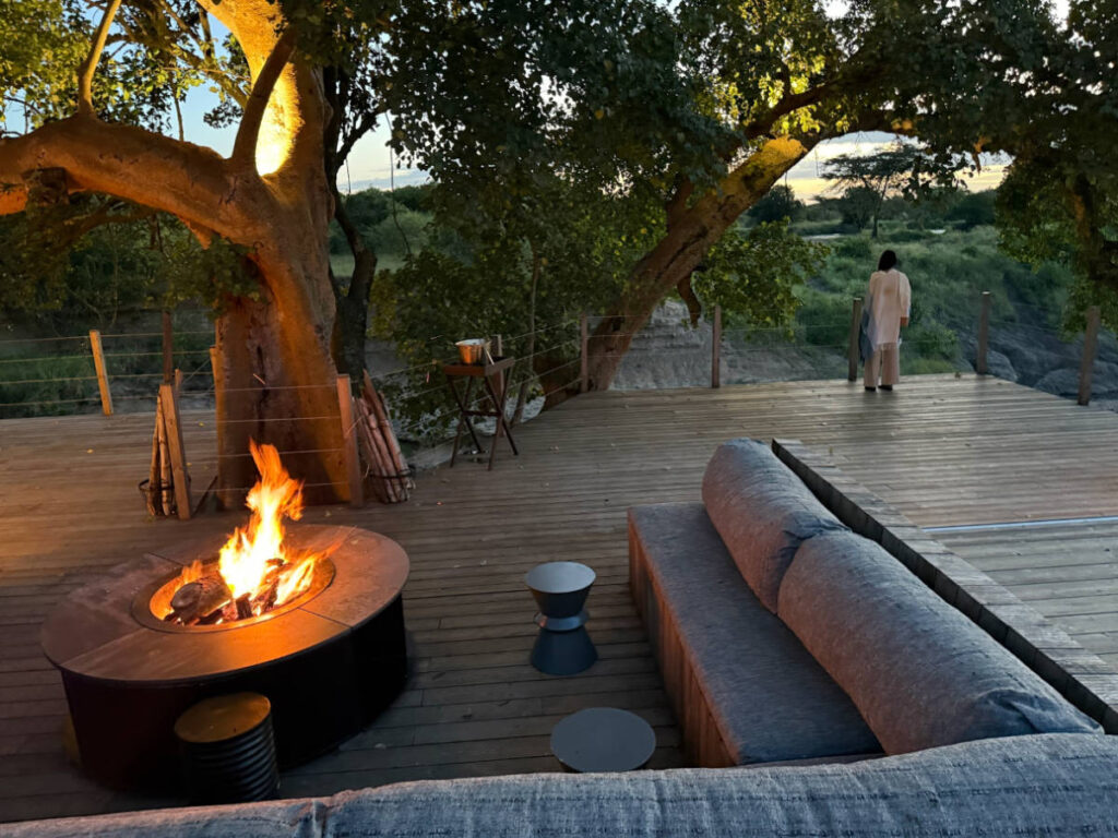 View of the lounge seats and the campfire on the deck at the camp