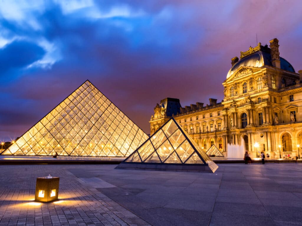 Night view of the illuminated iconic Louvre Museum in Paris