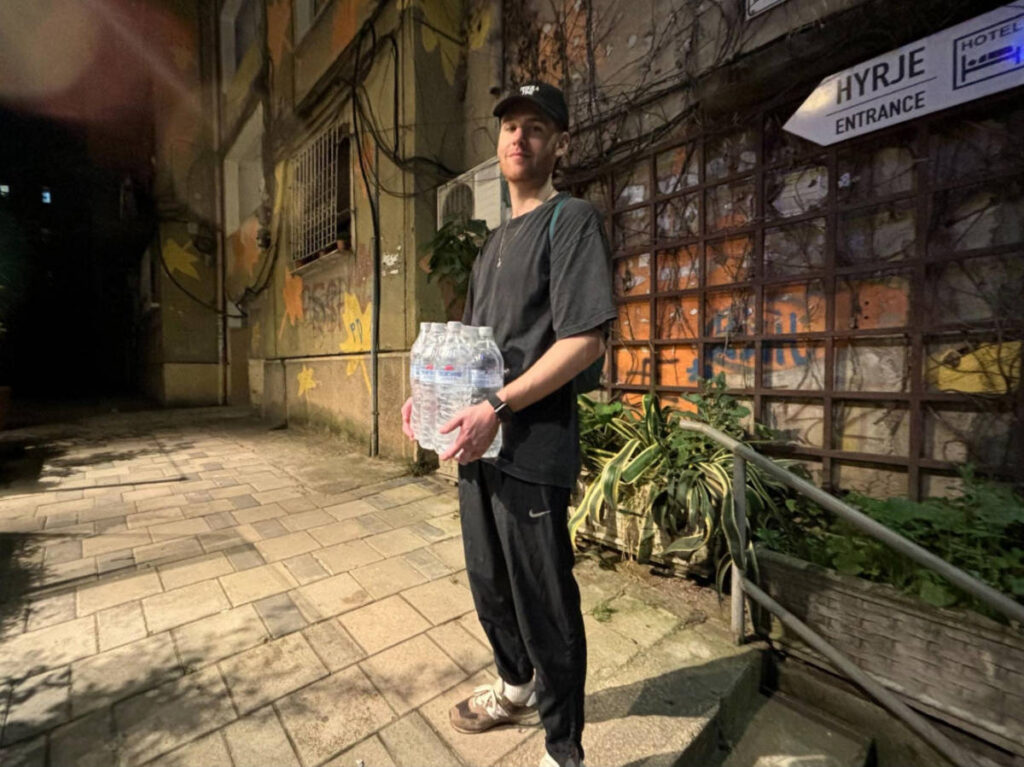 A man carrying bottles of water