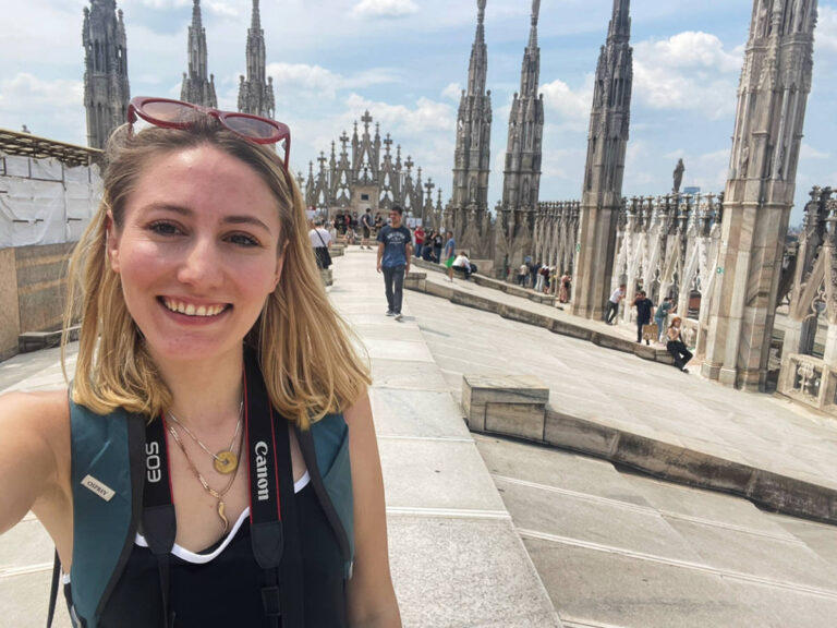 The author, Sky Ariella smiling for a selfie at the top of Milan Cathedral