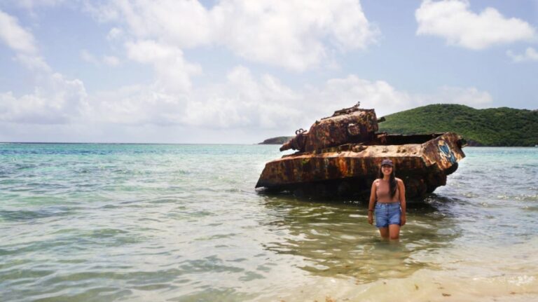 Author Vanessa posing with the military tank in Flamenco Beach