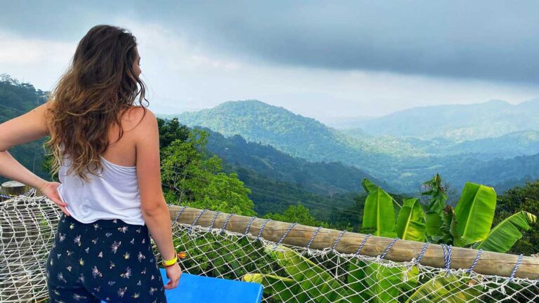 The author Sky Ariella during her solo travel in Columbia with the view from the mountains of Minca Colombia
