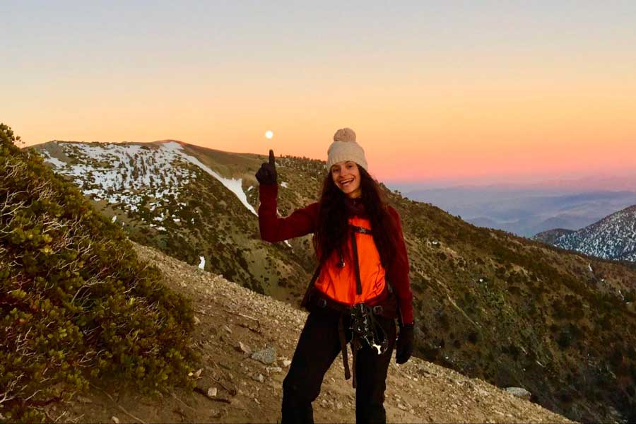 The author pointing the supermoon during her hike in Mt. Baldy