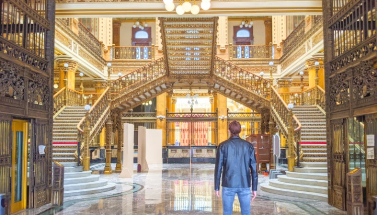 Travel Lemming founder Nate at the Mexico City post office, staring at the gold stairs