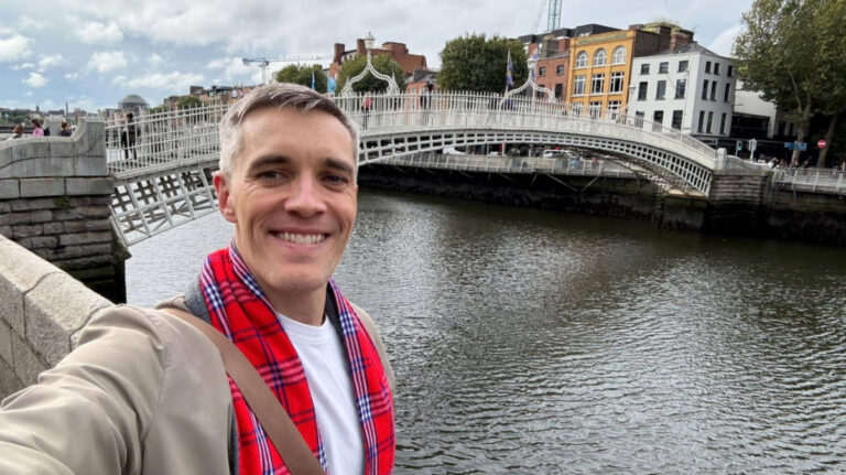 Travel Lemming Founder, Nate Hake, smiling for a photo with the at the Ha’penny Bridge in Dublin
