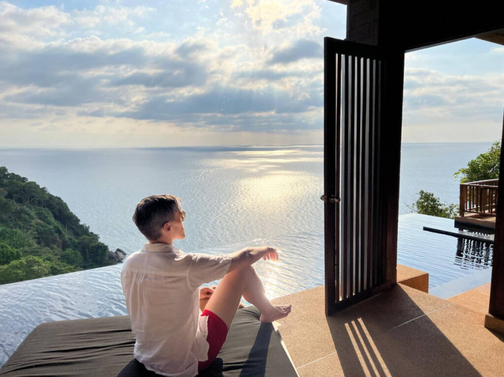The author, Nate Hake admiring the view from a hotel with infinity pool in Thailand