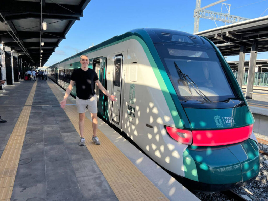 The author, Nate Hake smiling for a photo beside the Tren Maya