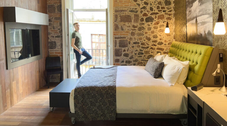 Nate leaning on a door to the balcony in Mumedi