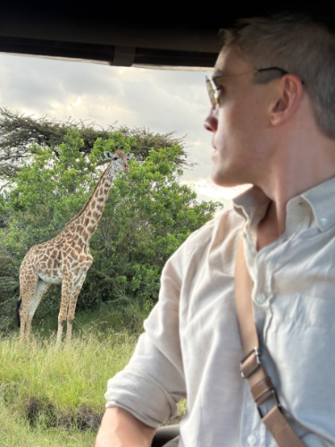 Travel Lemming founder Nate Hake, staring the giraffe from the safari vehicle