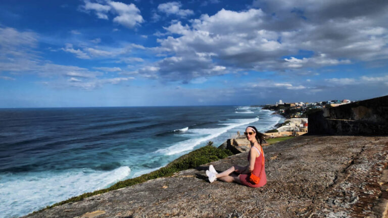 The author, Niamh Hayes smiling for a photo with sea view in Puerto Rico