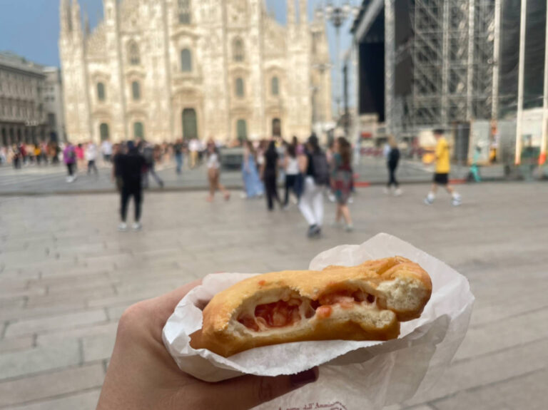 Closeup look of the panzerotti in front of the Duomo di Milano