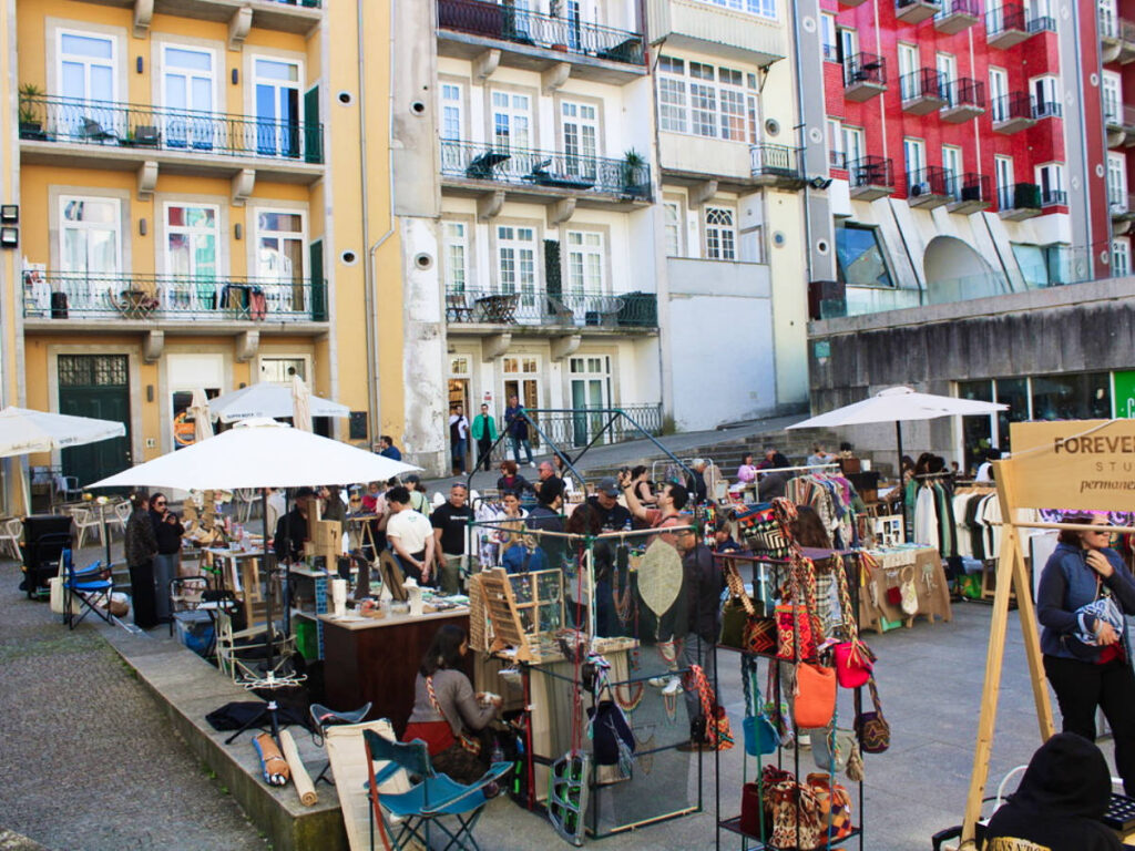 People walking around the outdoor market in Porto