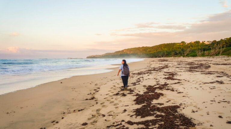 Author Vanessa Ramos strolling on Playa El Pastillo beach in Isabela