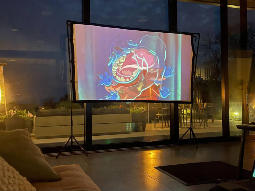 The projector screen in the dark room at AutoCamp