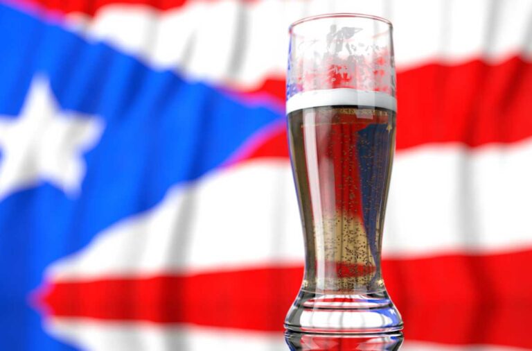 A glass of beer in front of the Puerto Rican flag