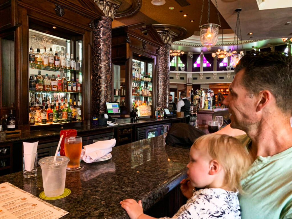 The author's husband and toddler in front of the bar counter at Raglan Road