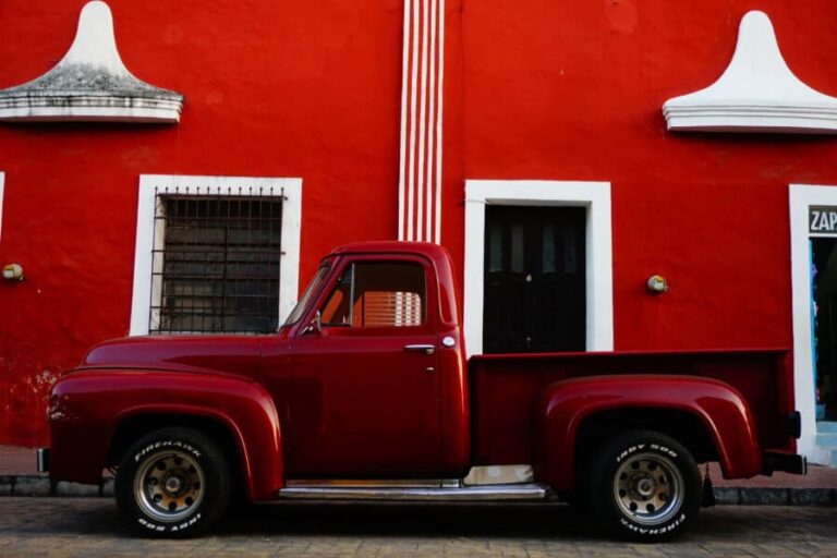 A red truck parked near a read building