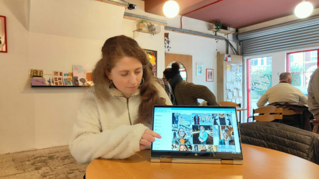 The author Ruthie showing the AI travel influencer from her device