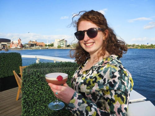 The author Ruthie Walters, holding a cocktail on the terrace at voco St. David's Cardiff