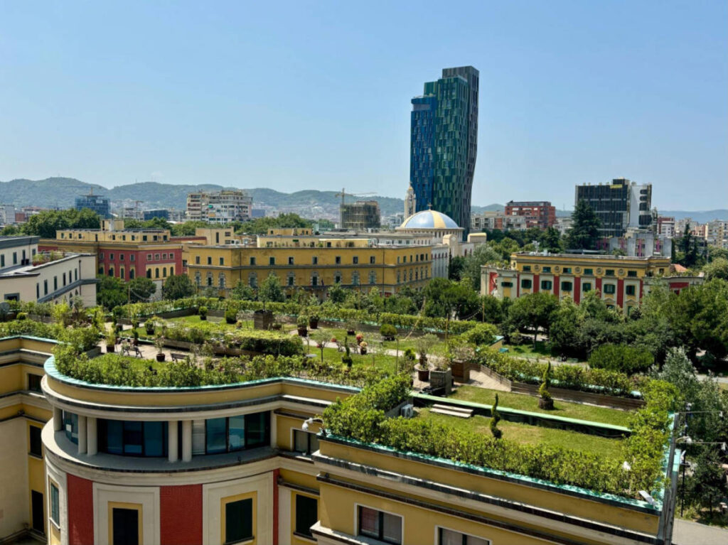 Overlooking view of the greenery on top of the building and the city skyline in Tirana 