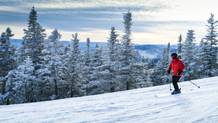 A skier skiing down at Stowe Mountain Resort