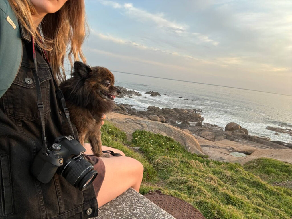 The author Sky Ariella and her dog enjoying the beach in Porto