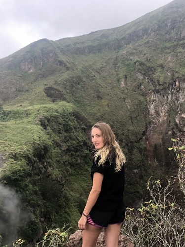 Sky Ariella looking at the camera with a overlooking view on her bacground