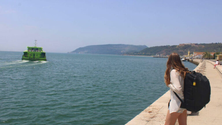 Travel Lemming writer Sky, looking at the ocean in Portugal while carrying her Topo Designs Global Travel Bag