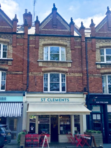 View of the light yellow storefront of St Clements