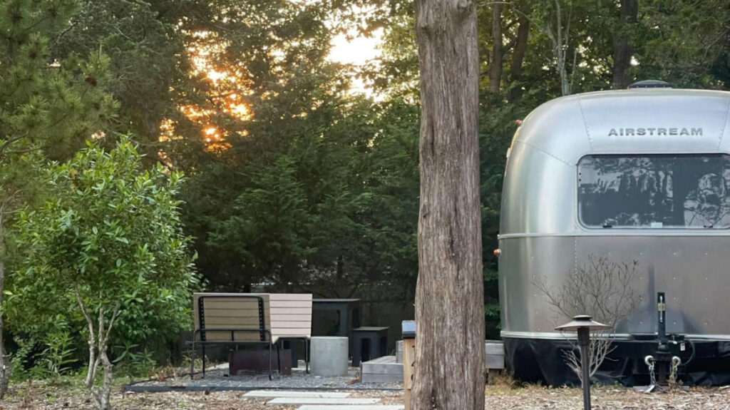 View of the campgrounds of AutoCamp, Cape Cod at sunset